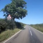 Road with double bend warning sign