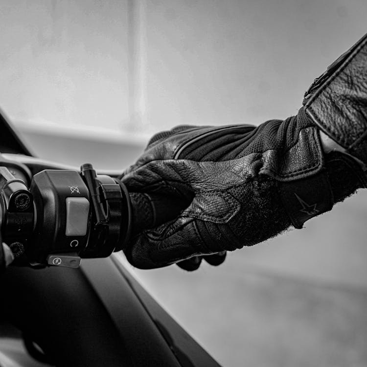 Gloved hand on motorcycle handlebar