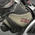 Gloved hand on motorcycle throttle