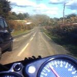 Motorcycle overtaking car on country lane