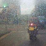 Motorcycle on wet road at traffic light
